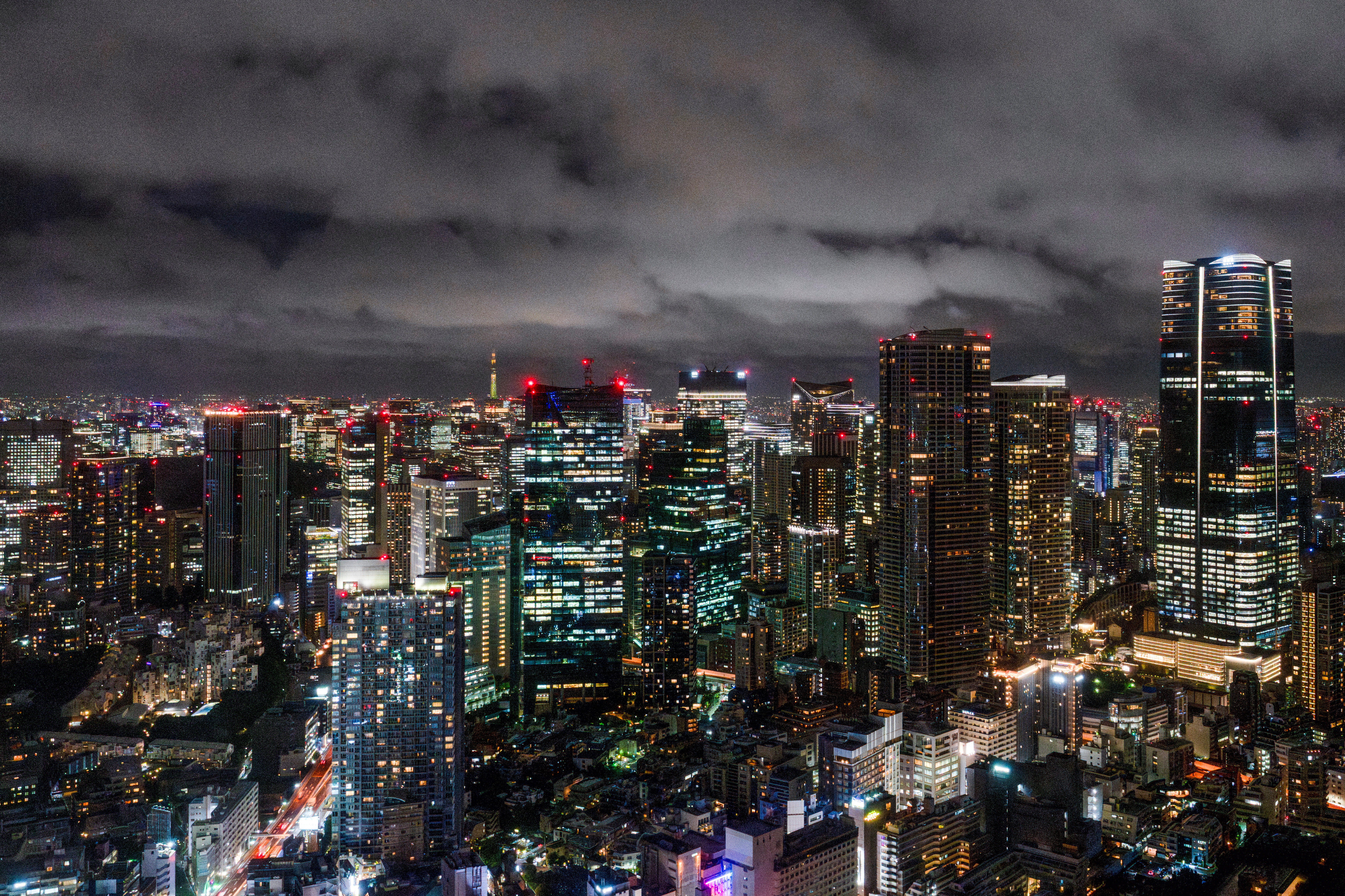 Roppongi night skyline with neon-lit streets and Tokyo Tower in the distance