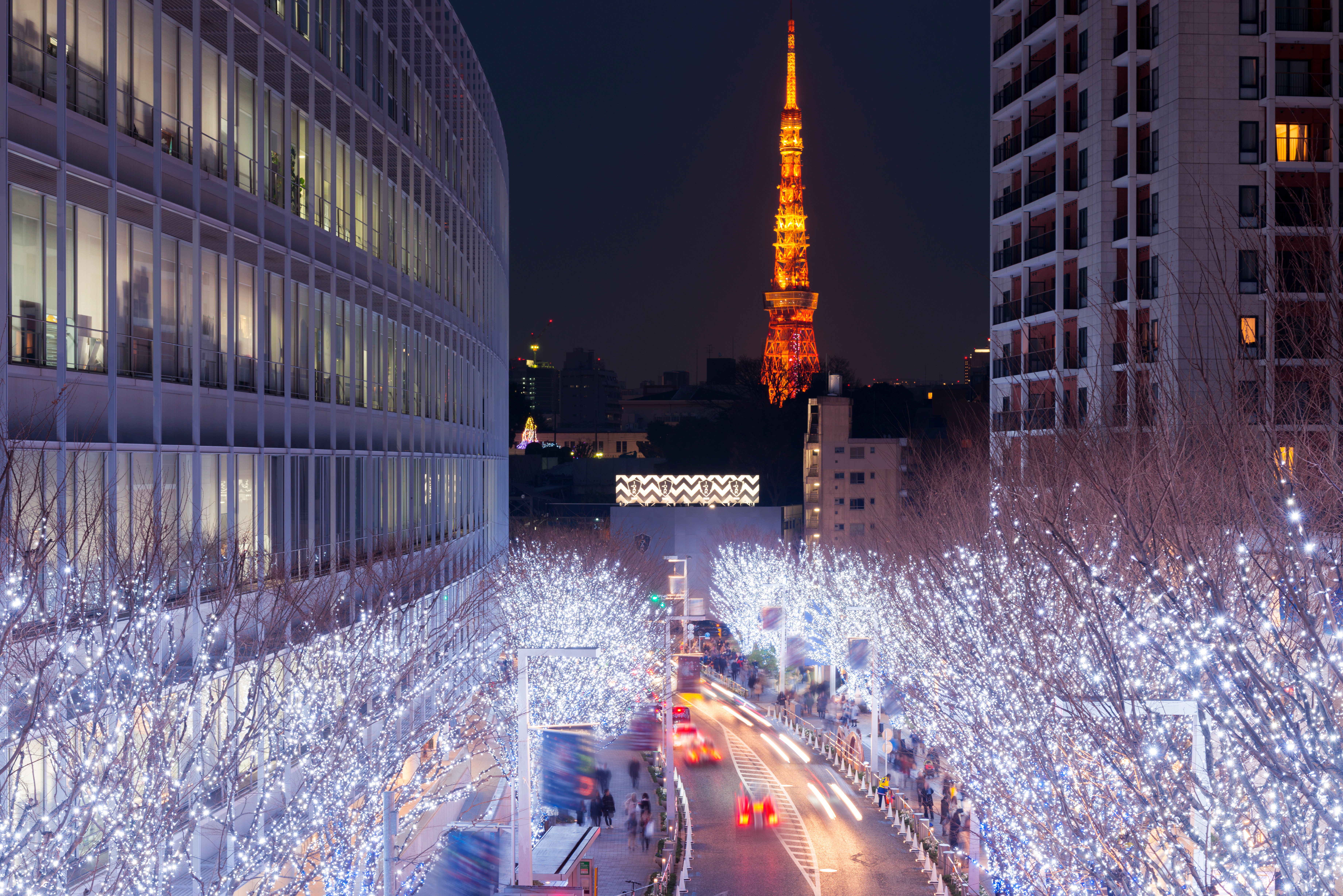 Roppongi night skyline with neon-lit streets and Tokyo Tower in the distance