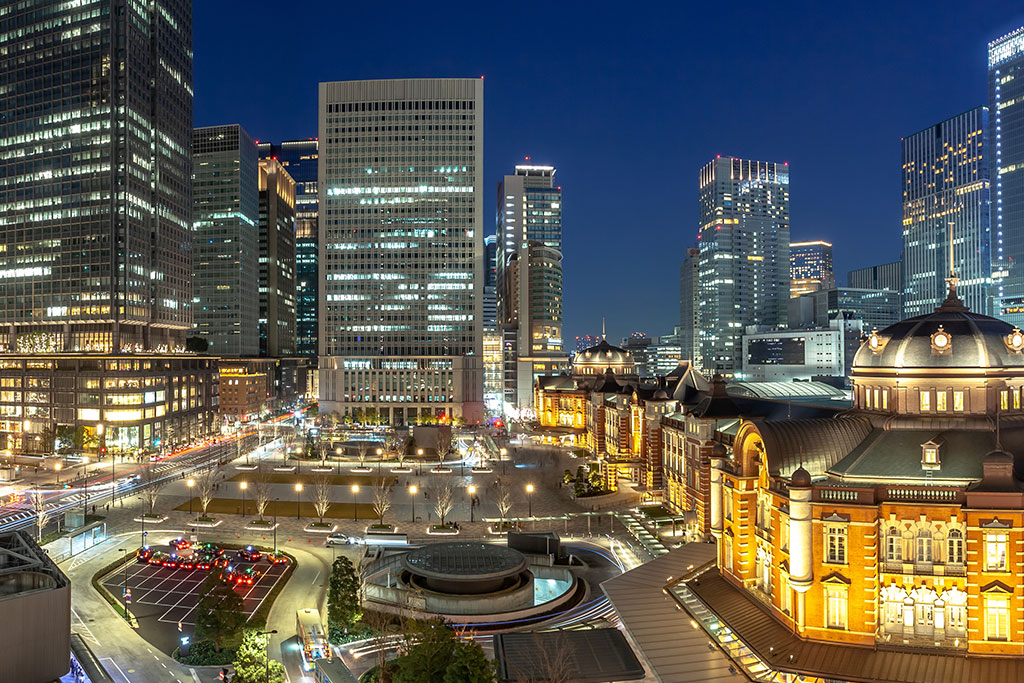 Tokyo night skyline with neon-lit streets symbolizing a discreet, international hub
