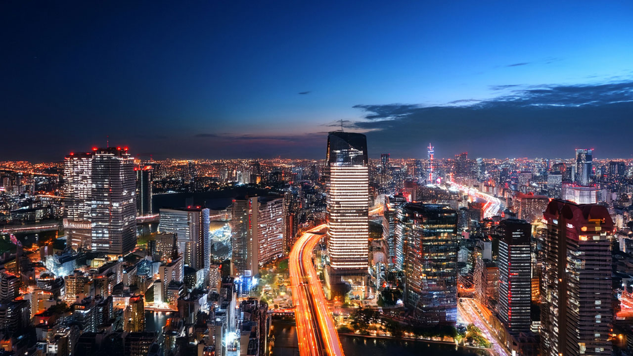 Tokyo night skyline with neon-lit streets symbolizing a discreet, international hub