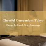 Adult Japanese companion and foreign guest sharing a bright, relaxed conversation in a Tokyo hotel room