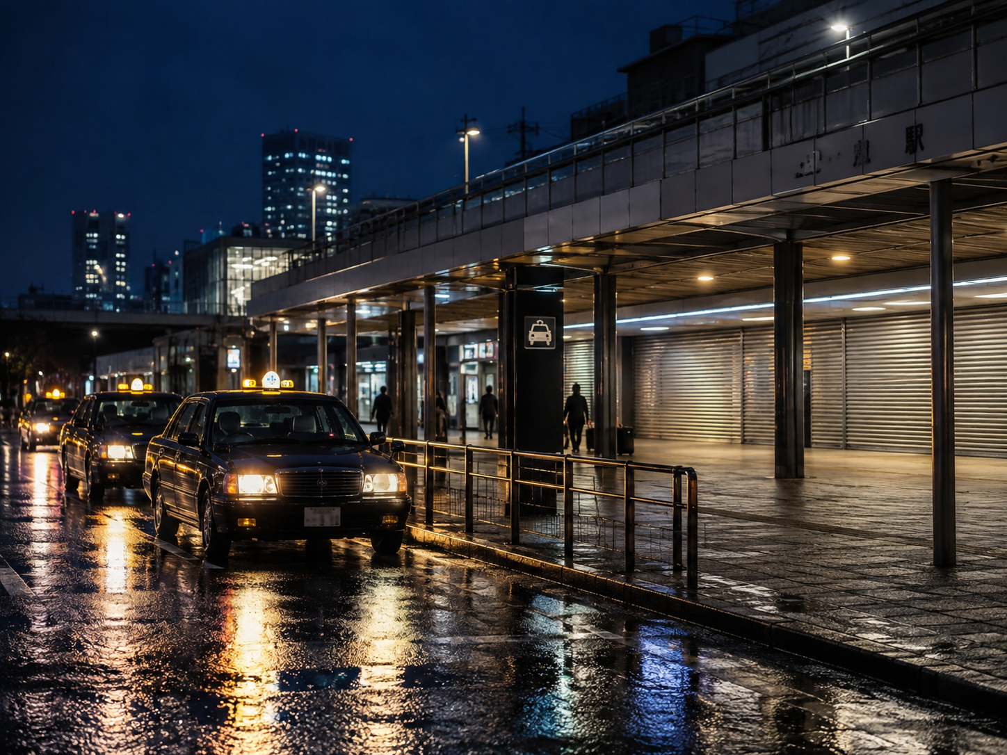 Taxi lights outside a closed Tokyo station entrance after midnight
